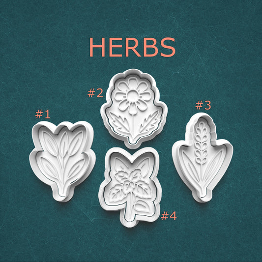 Set of four herb molds with leaf patterns on a teal background