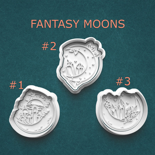 Three fantasy moon-shaped cookie cutters with designs on a teal background, labeled '#1', '#2', and '#3'.