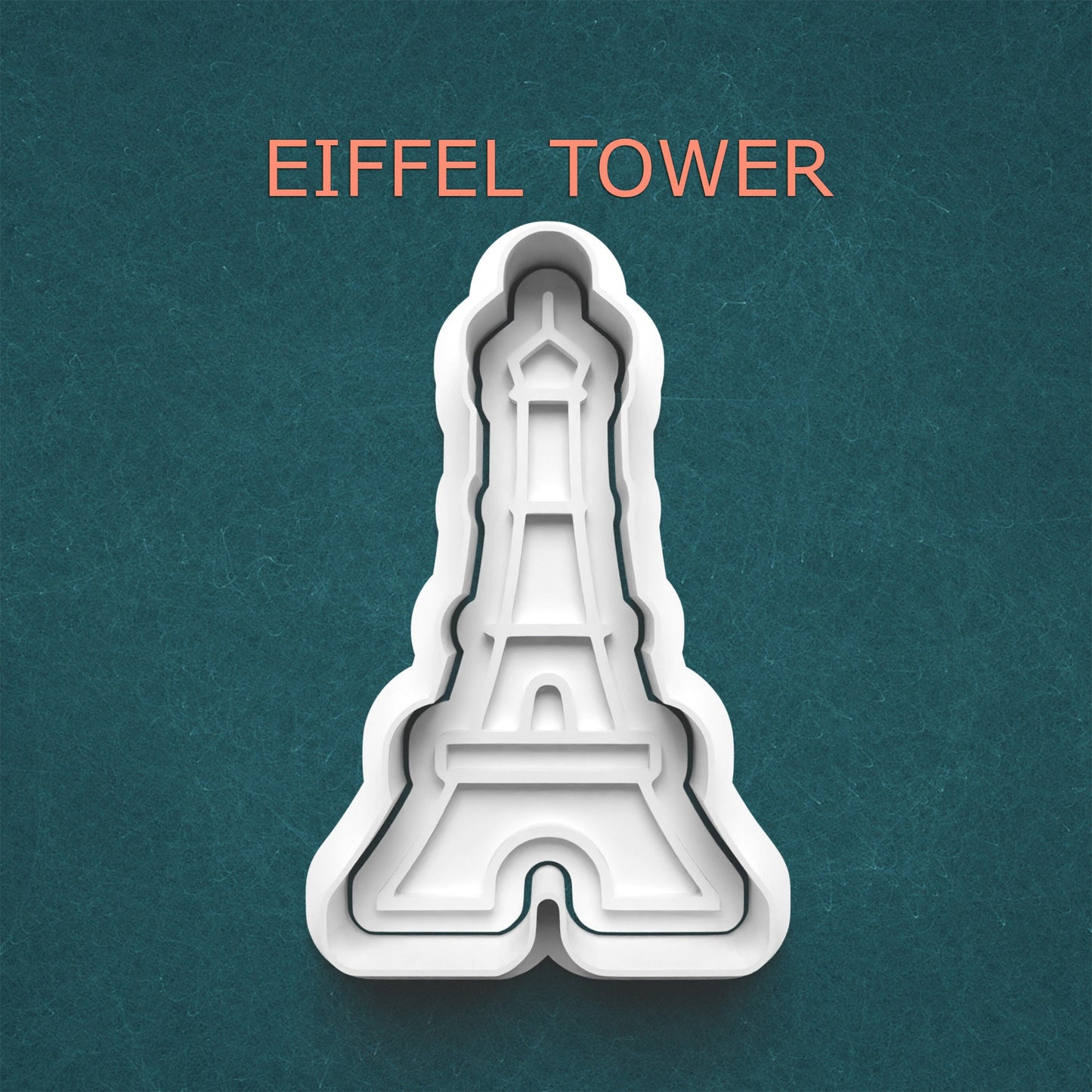 Eiffel Tower cookie cutter on a teal background