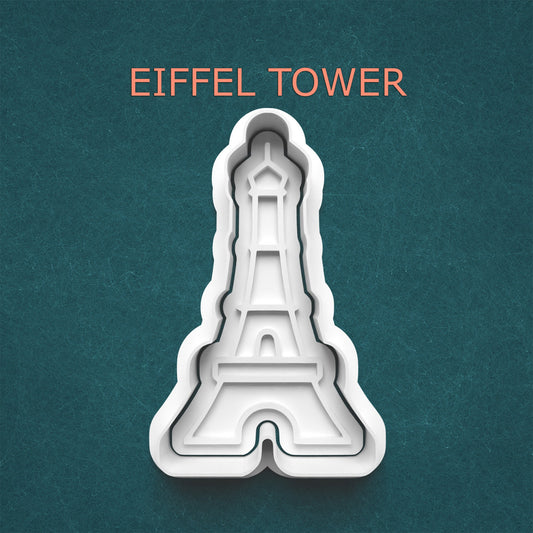 Eiffel Tower cookie cutter on a teal background