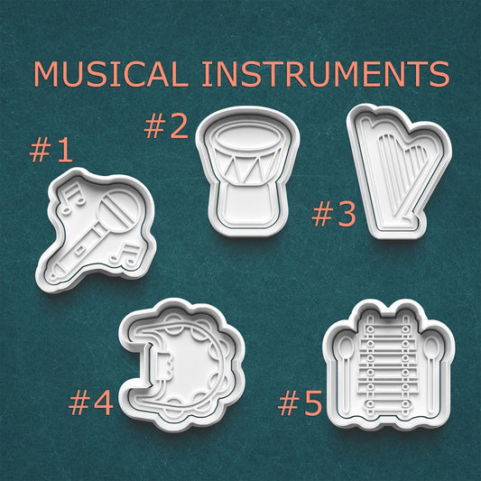 Set of five cookie cutters shaped like musical instruments on a teal background.