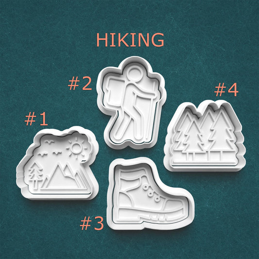 Set of four hiking-themed cookie cutters on a teal background