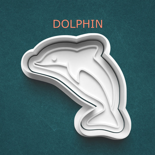 Dolphin-shaped cookie cutter on a teal background with 'DOLPHIN' text above.