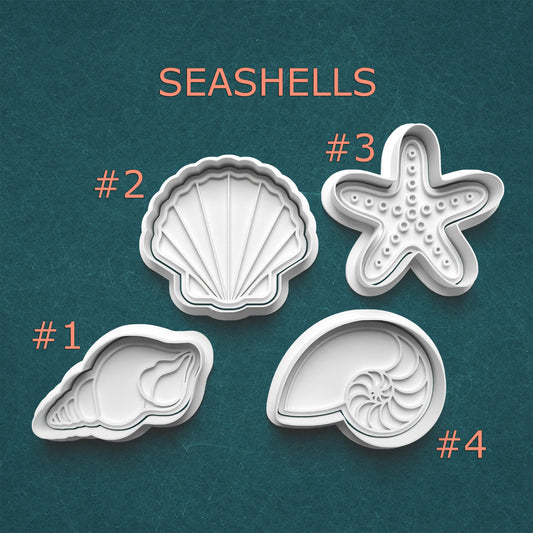Set of seashell-shaped cookie cutters on a teal background