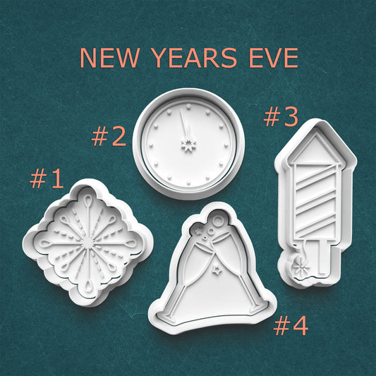 Set of New Year's Eve-themed cookie cutters on a teal background