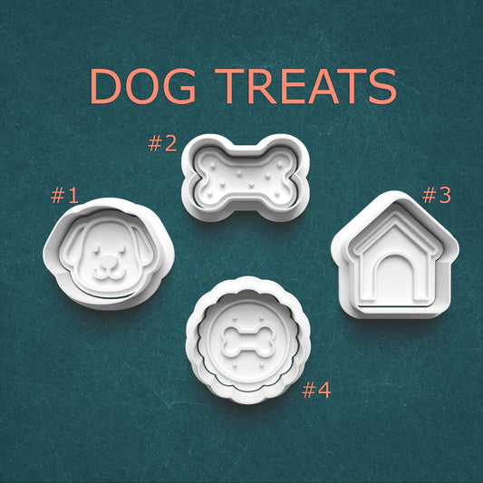 Dog treat molds with shapes of a dog, bone, house, and circle on a teal background.