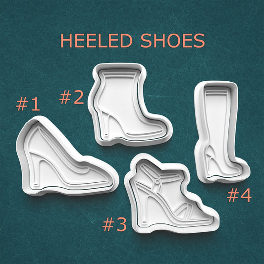 Set of cookie cutters shaped like heeled shoes on a teal background