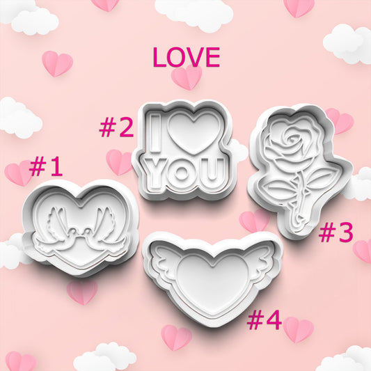 Set of cookie cutters with heart, 'I love you', and rose designs on a pink background with hearts.