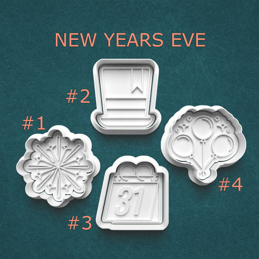 Four New Year's Eve-themed cookie cutters on a teal background