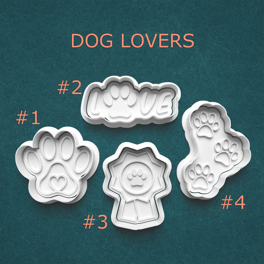 Set of four dog-themed cookie cutters with paw prints and 'LOVE' on a teal background, labeled 'Dog Lovers'.