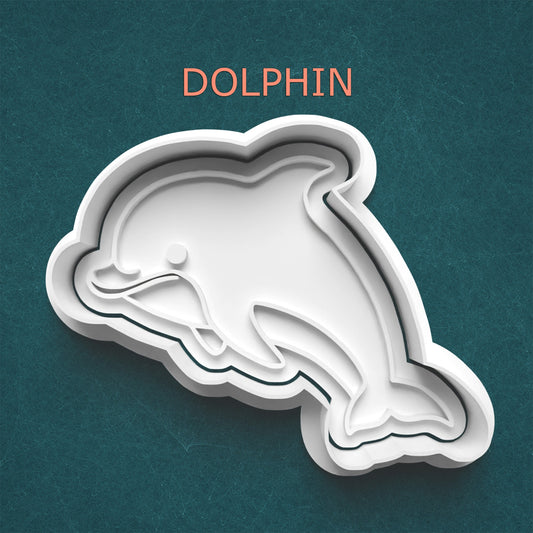 Dolphin-shaped cookie cutter on a teal background with 'DOLPHIN' text above.