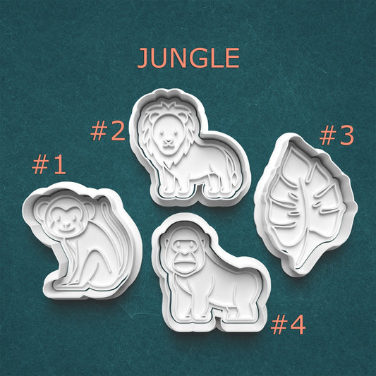 Set of four jungle-themed cookie cutters on a teal background