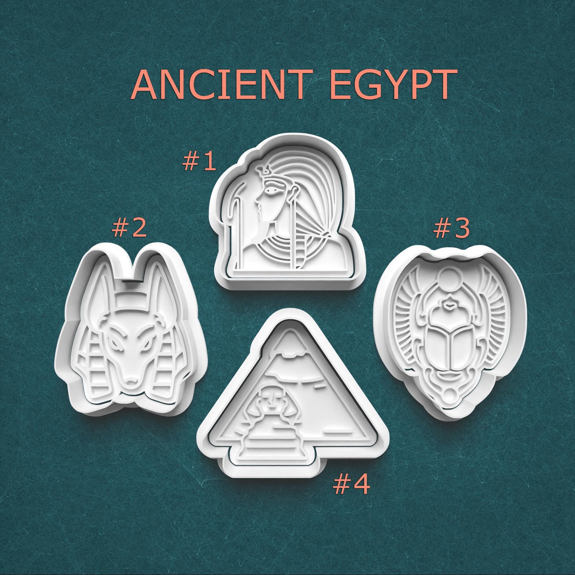 Set of four cookie cutters with ancient Egyptian designs on a teal background.