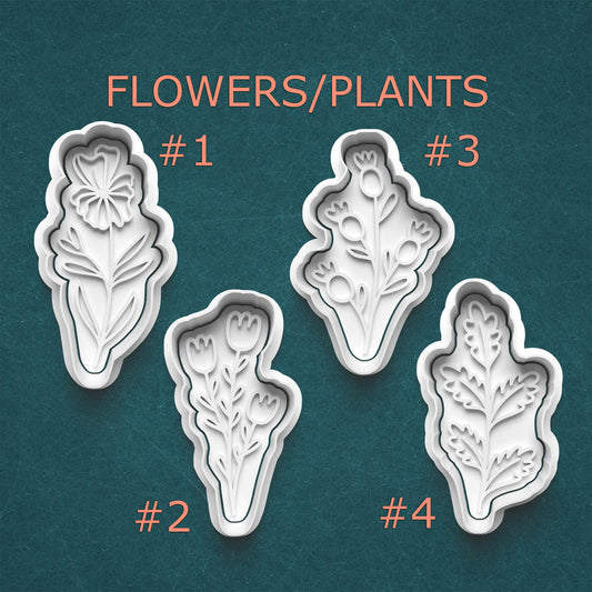 Set of four floral and leaf-shaped cookie cutters on a teal background