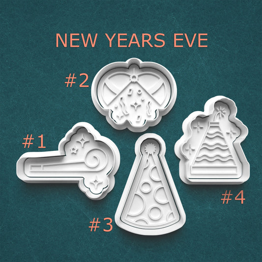 Four New Year's Eve-themed cookie cutters on a teal background