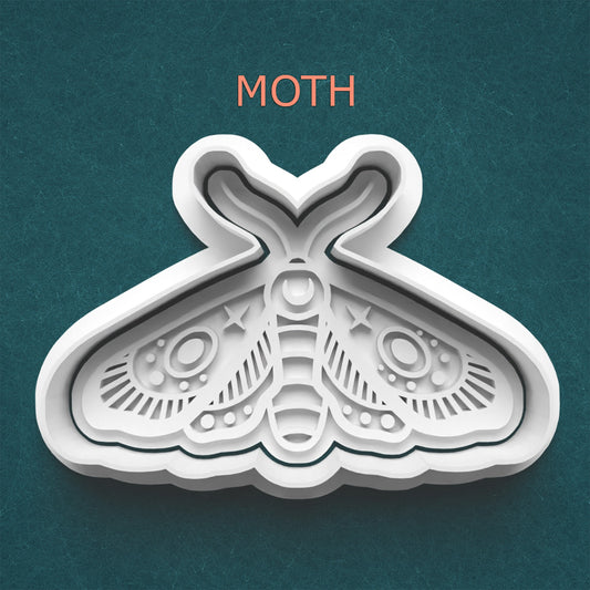 White moth-shaped cookie cutter on a teal background with 'MOTH' text above.