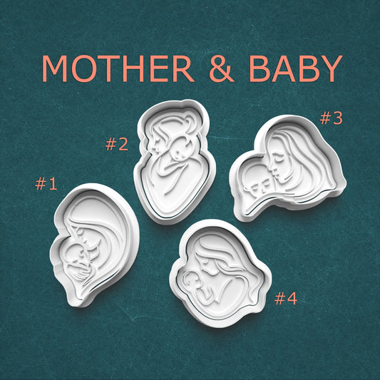 Four cookie cutters shaped like a mother and baby on a teal background