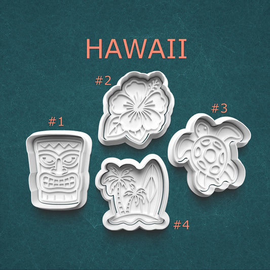 Set of four cookie cutters with Hawaii-themed designs on a teal background
