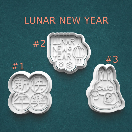 Three lunar new year-themed cookie cutters on a teal background