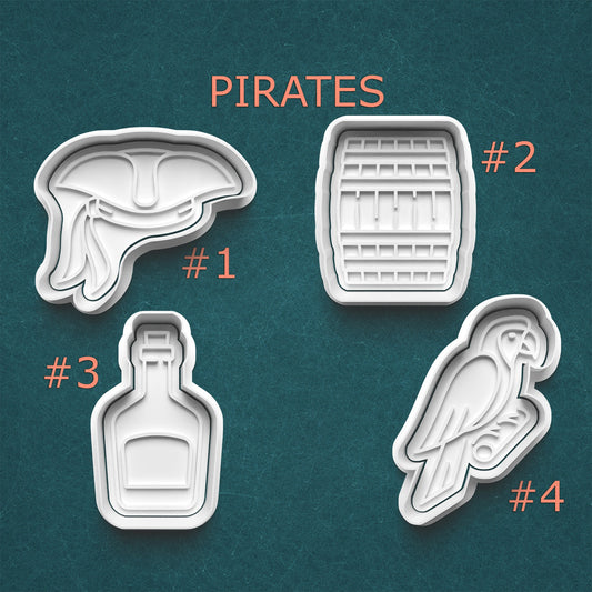 Set of pirate-themed cookie cutters on a teal background