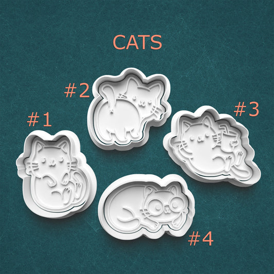 Four cat-shaped cookie cutters on a teal background with 'CATS' text above.