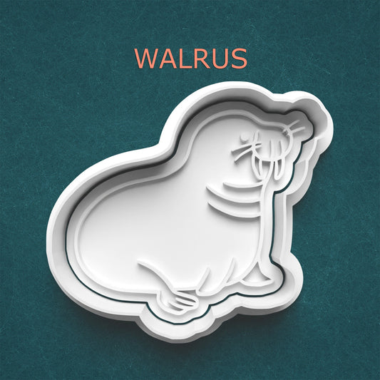 Cookie cutter shaped like a walrus on a teal background