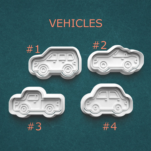 Four vehicle-shaped cookie cutters on a teal background with 'VEHICLES' text above.