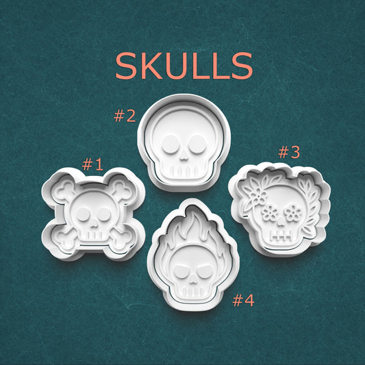 Four skull-shaped cookie cutters with numbers on a teal background