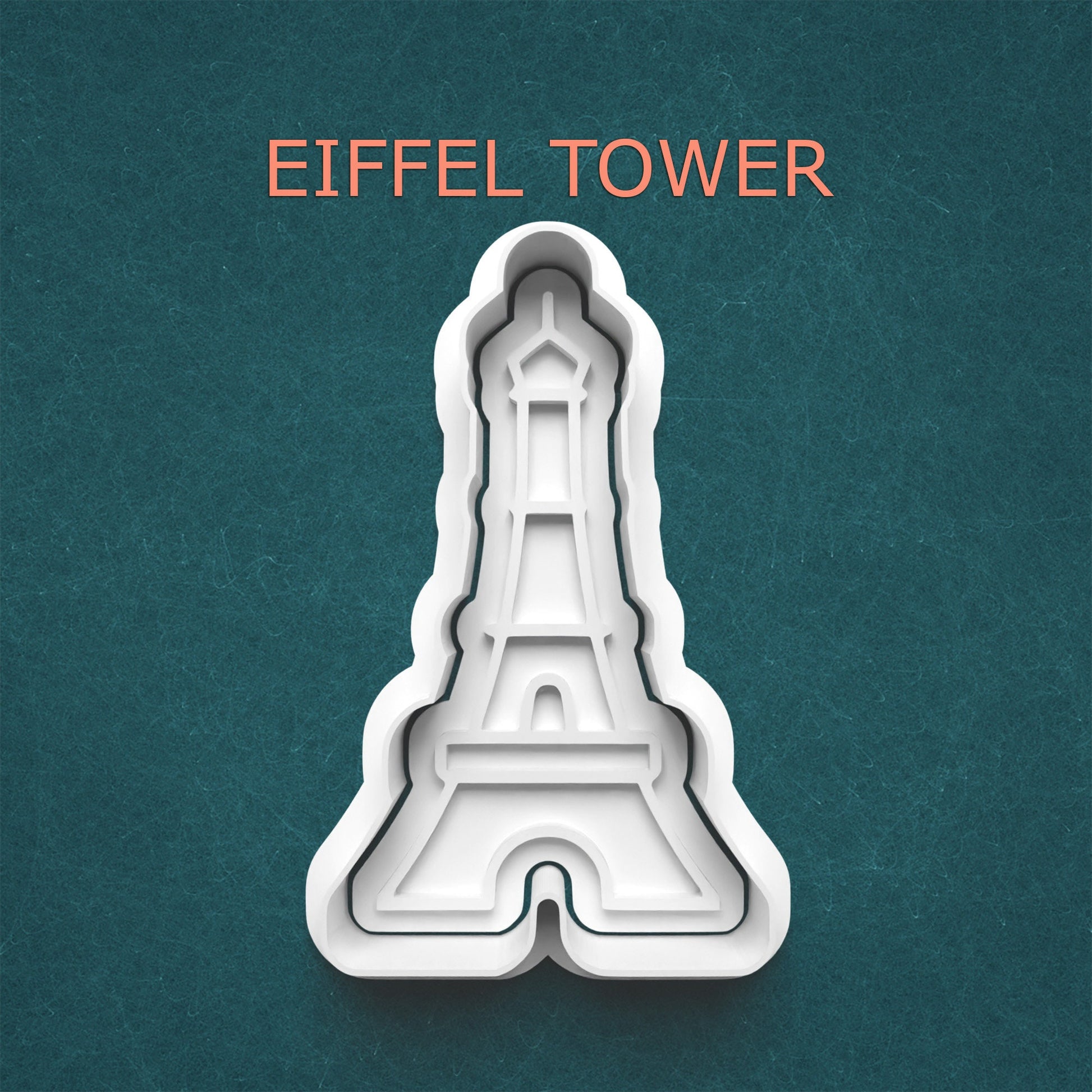 Eiffel Tower cookie cutter on a teal background
