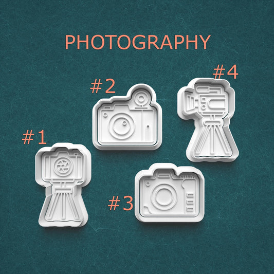 Four camera-shaped cookie cutters on a teal background with 'PHOTOGRAPHY' text.