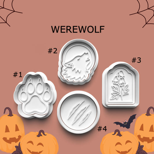Set of Halloween-themed cookie cutters with designs of a paw print, wolf, tombstone, and paw prints on a brown background with pumpkins and bats.