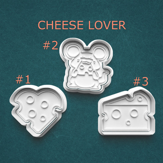 Three cheese-themed cookie cutters with 'Cheese Lover' text on a teal background