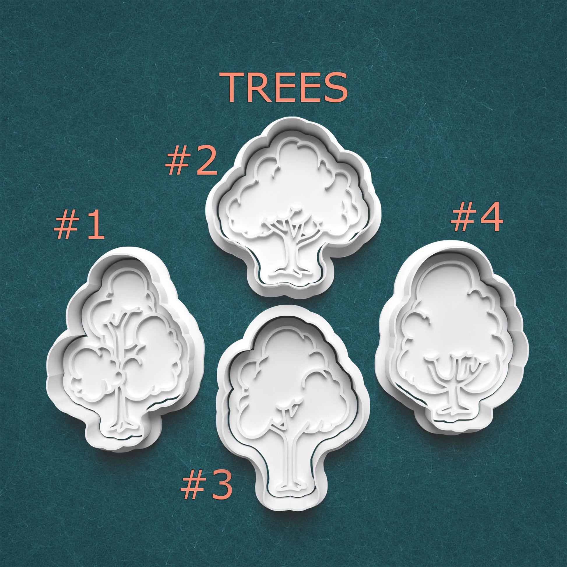 Four tree-shaped cookie cutters on a teal background