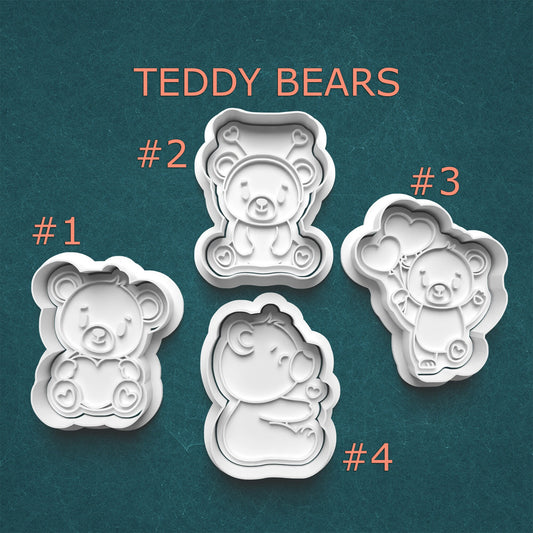 Four teddy bear-shaped cookie cutters on a teal background