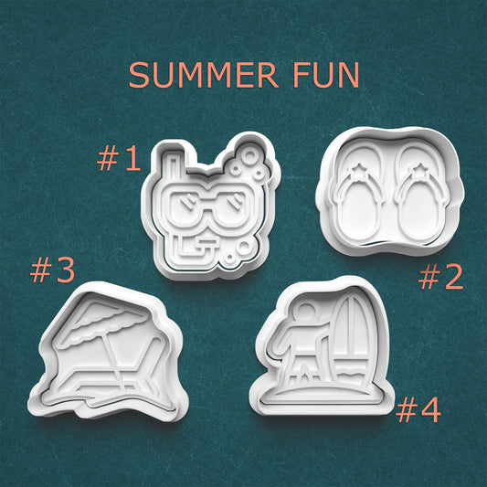 Four cookie cutters with summer-themed designs on a teal background
