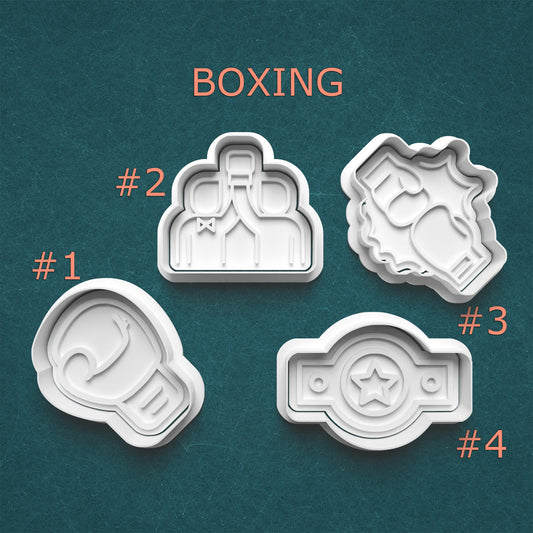 Four boxing-themed cookie cutters on a teal background with 'BOXING' text above.