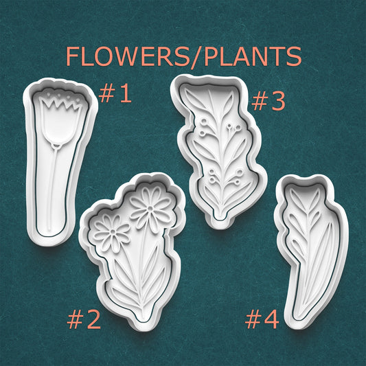 Set of four floral and leaf-shaped cookie cutters on a teal background