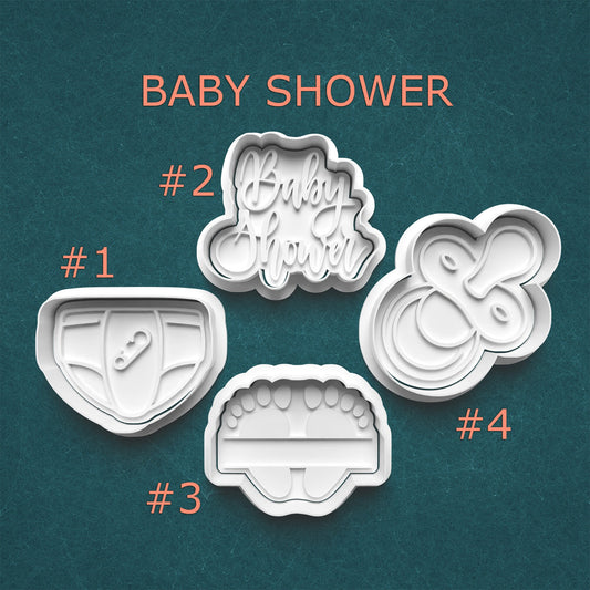 Set of baby shower-themed cookie cutters on a teal background