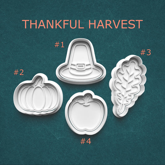 Set of four cookie cutters with 'Thankful Harvest' text on a teal background