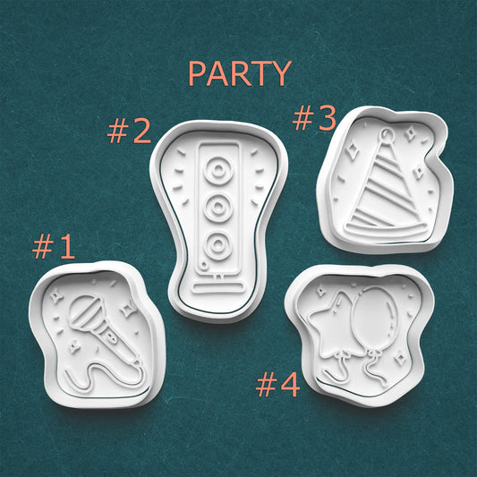 Four party-themed cookie cutters on a teal background