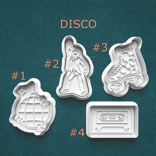 Set of four disco-themed cookie cutters on a teal background