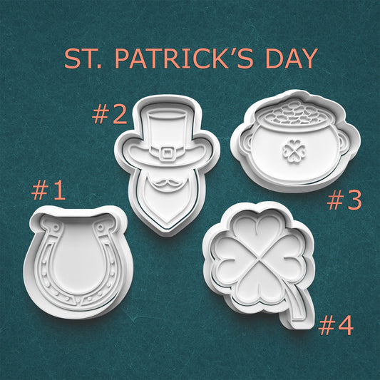 Four St. Patrick's Day cookie cutters on a teal background