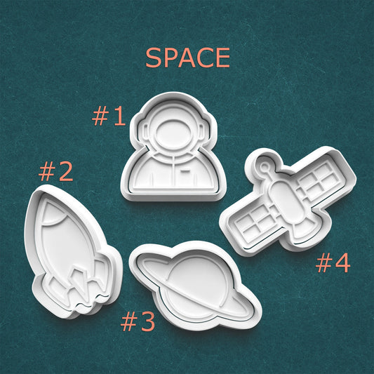 Four space-themed cookie cutters on a teal background with 'SPACE' text above.
