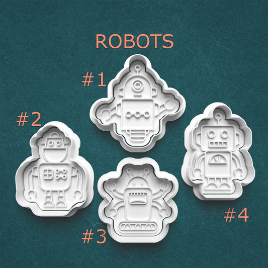 Set of four robot-shaped cookie cutters on a teal background