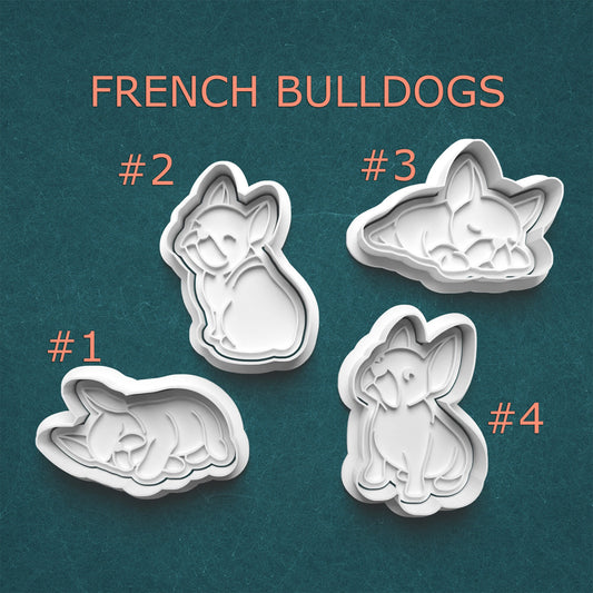 Four French Bulldog-shaped cookie cutters on a teal background