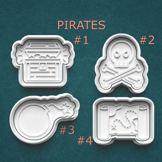 Four pirate-themed cookie cutters on a teal background