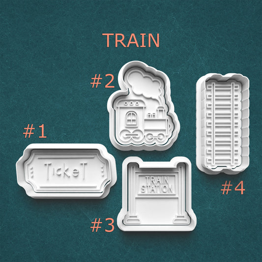Set of train-themed cookie cutters on a teal background