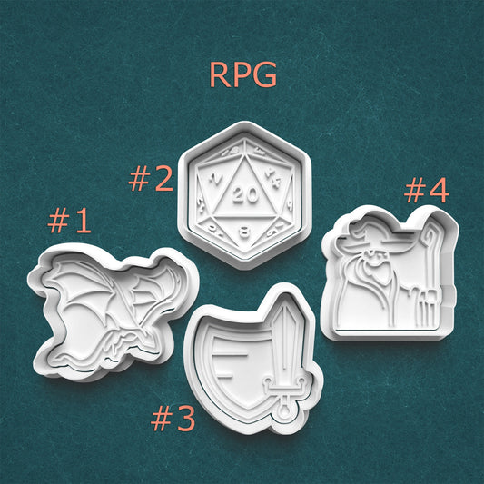 Four cookie cutters with RPG-themed designs on a teal background