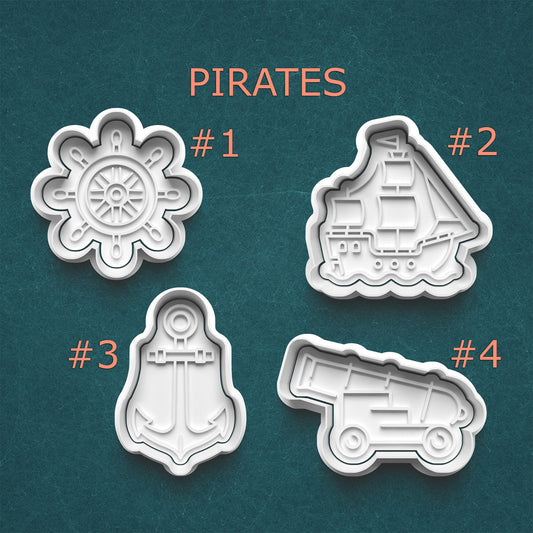 Four pirate-themed cookie cutters on a teal background