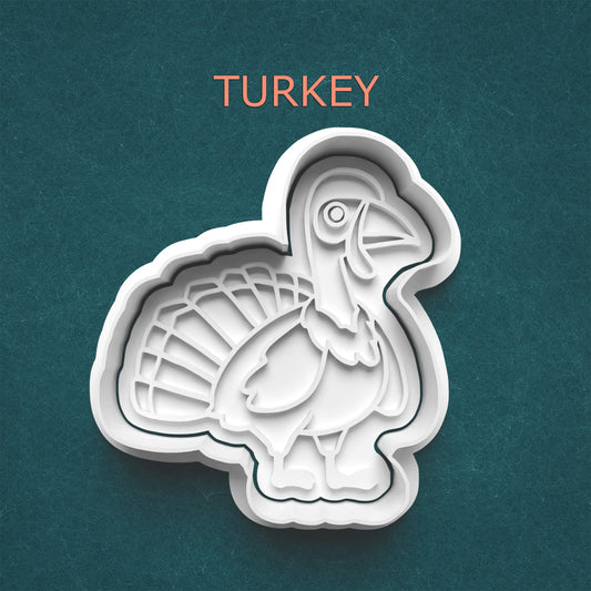 Turkey-shaped cookie cutter on a teal background with 'TURKEY' text above.
